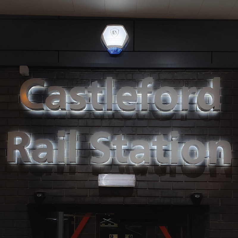 3D fabricated letters in silver with white halo illumination around the edges.
