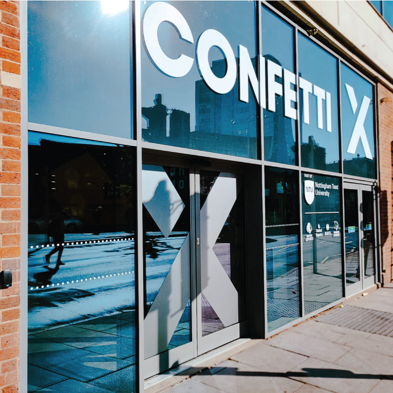Main Entrance to Confetti X, the doors and surrounding area are full glass.
