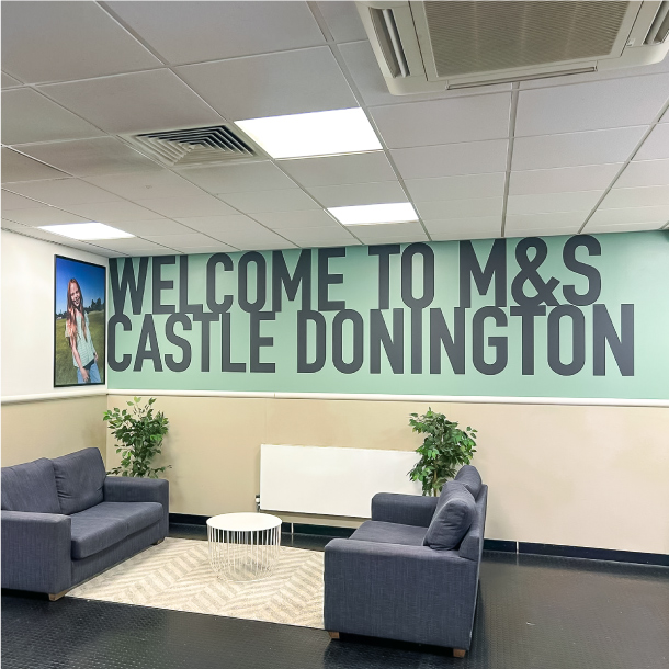 A breakroom at M&S Castle Donnington with a welcome to M&S graphic on the wall