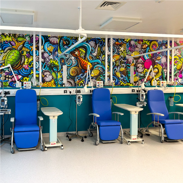 The walls of QMC Daycase transformed by a busy, colourful underwater scene vinyl wrap