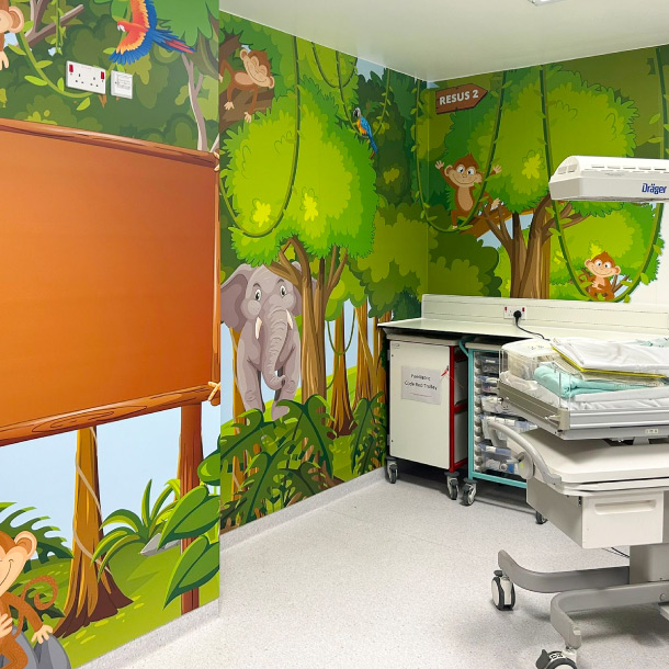 A paediatric resus room with a jungle theme wall wrap.